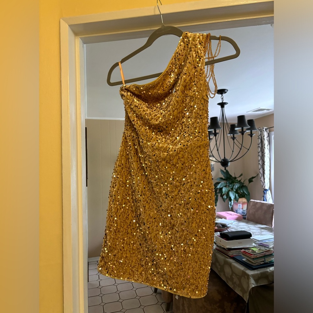 Brand new never with gold sequins dress one shoulder with beads.